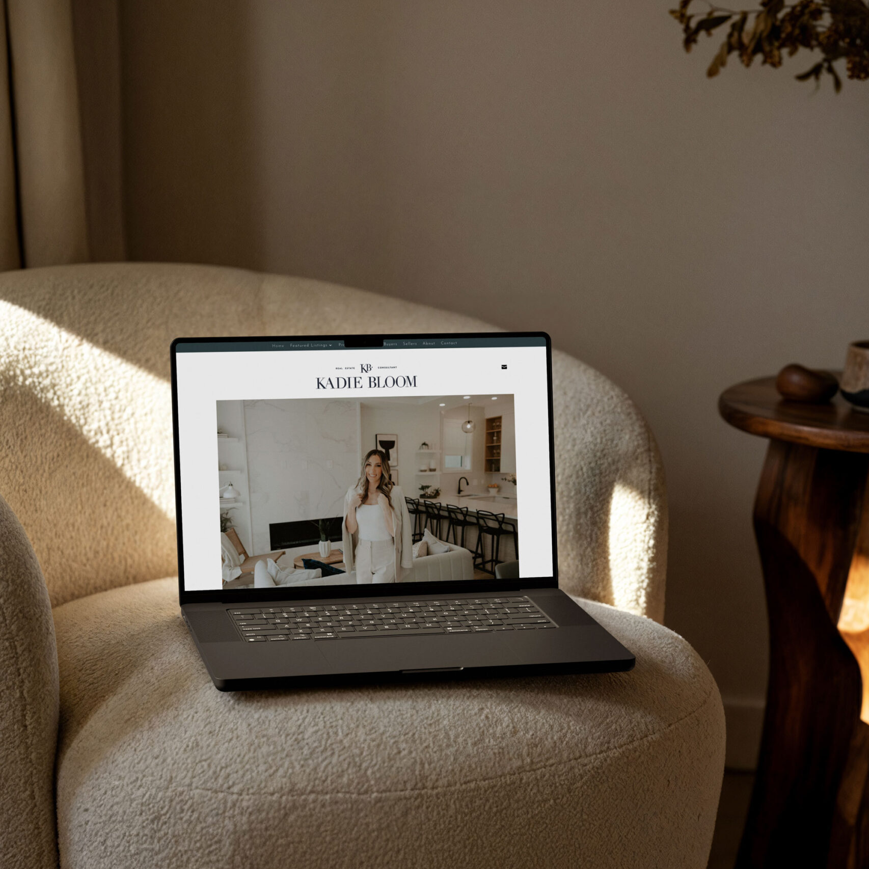 Laptop sitting on a chair, showing the website of real estate agent Kadie Bloom.