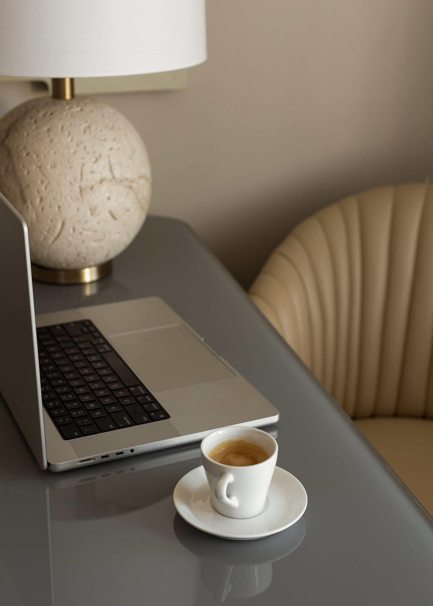 Sleek workspace with laptop and espresso, ideal for real estate agents using Showit to build polished websites.