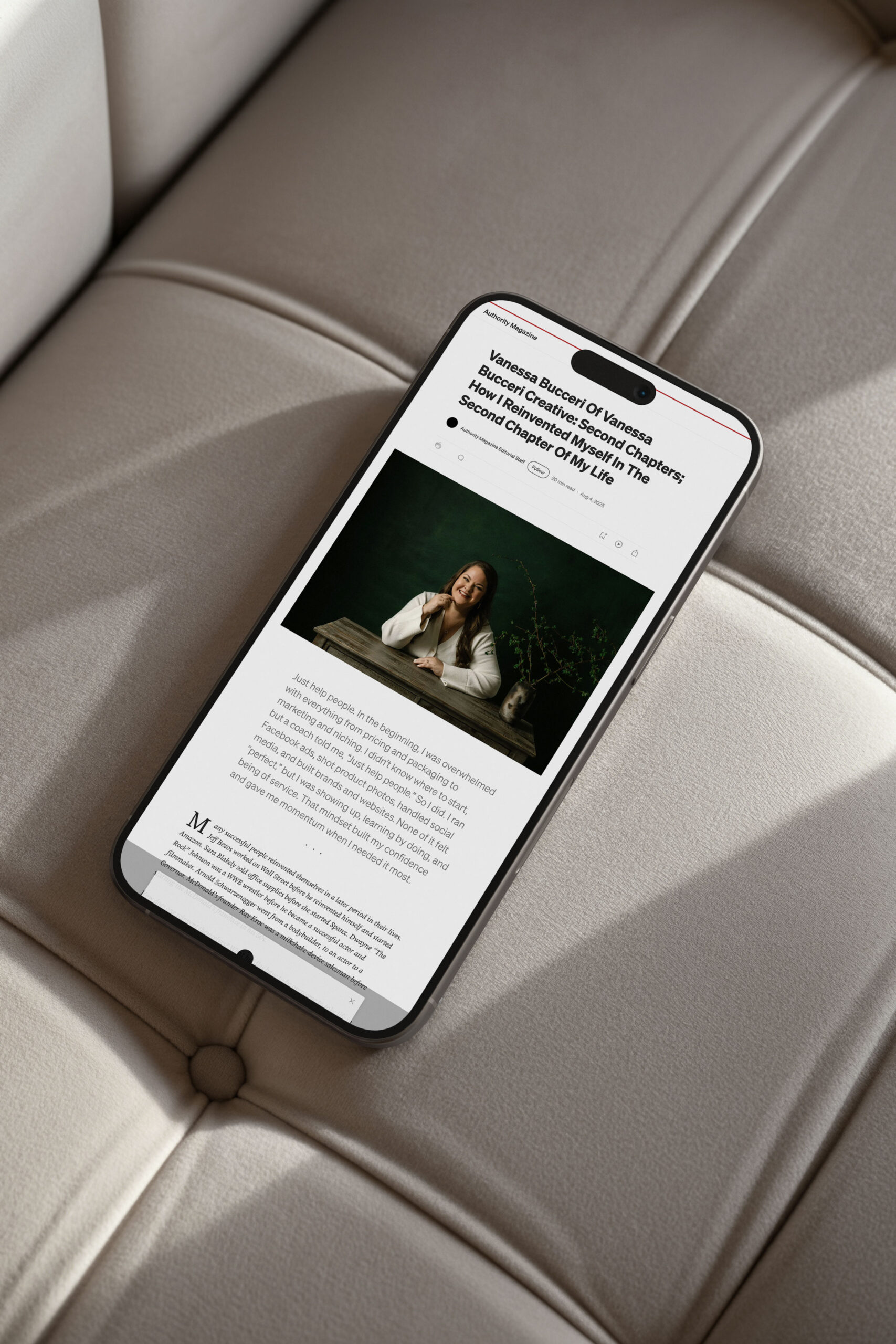 Mockup of Vanessa Bucceri’s Authority Magazine article titled “How I Reinvented Myself in the Second Chapter of My Life,” displayed on a mobile phone resting on a neutral-toned sofa.